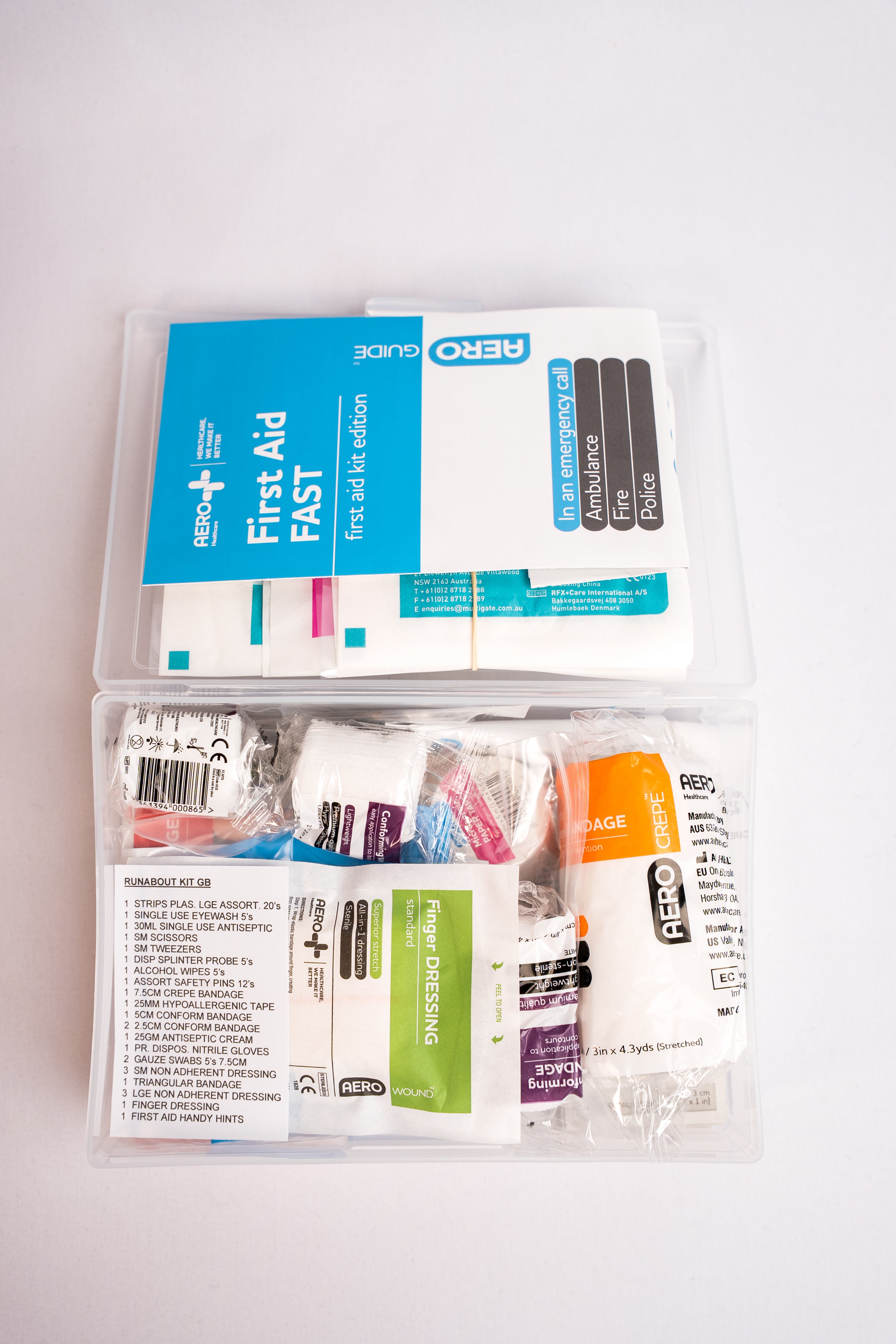 Open glove box first aid kit showing included first aid supplies.