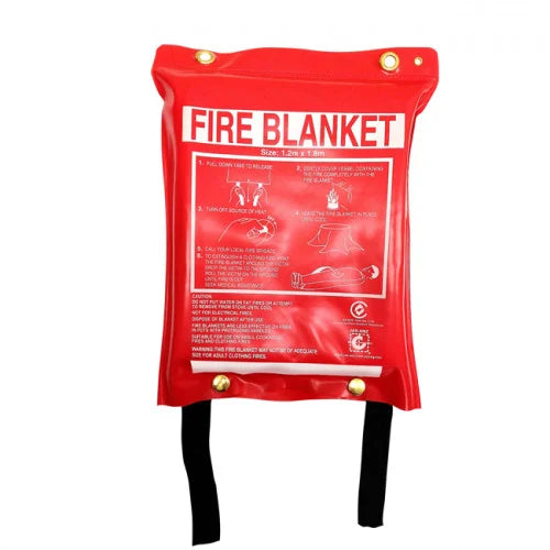 A red fire blanket with black straps and brass grommets, featuring a printed white instruction diagram on the front.