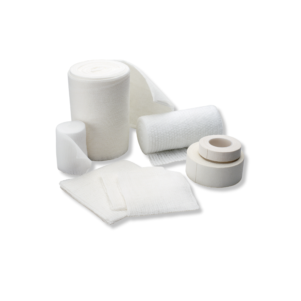 Various sizes of white bandages and dressings on a white background