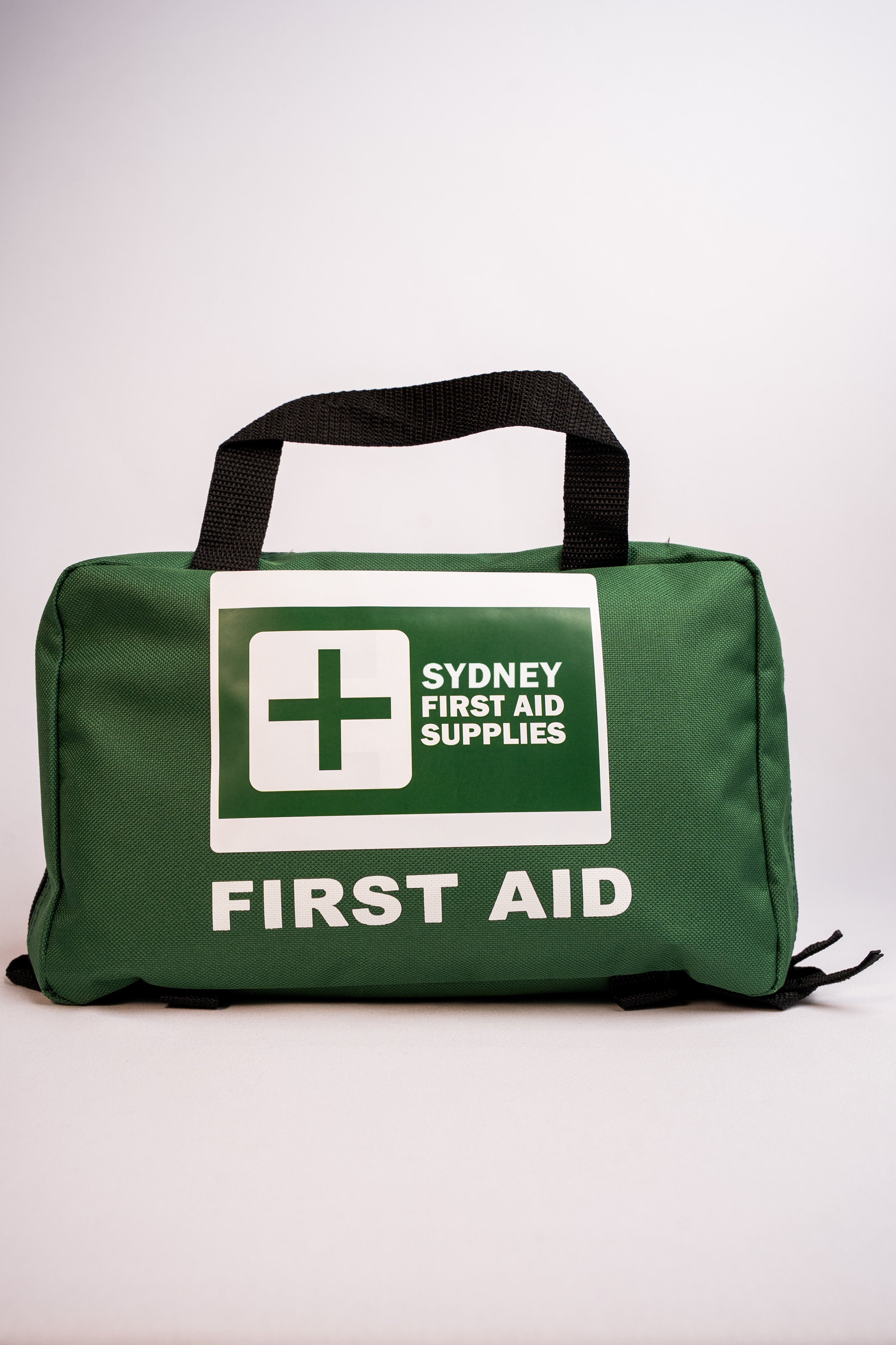 Green, fabric first aid bag with 'Sydney First Aid Supplies' branding on a white background